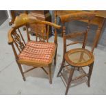 A late Victorian child's correction chair with a carved splat back,