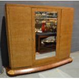An Art Deco ash and rosewood veneered triple door armoire or wardrobe in the manner of Jean Favre,