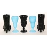A late 19th Century Davidson black pressed glass celery vase with relief moulded scrolls and