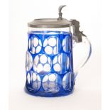 A 19th Century Bohemian glass tankard cased in blue over clear crystal and flash cut with printie