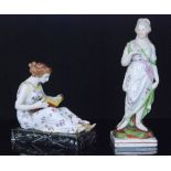 Two 19th Century Staffordshire figures, the first modelled as a lady stood holding a dove,