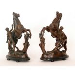 A pair of British stamped Marley style spelter horses on oval ebonised bases,
