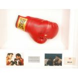 A framed Everlast boxing glove signed by Muhammad Ali and Joe Frazier, with certificate,