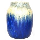 A large Ruskin Pottery crystalline glaze barrel vase decorated in green to yellow to blue,