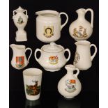 A collection of assorted early 20th Century crested china to include several jugs of varying form