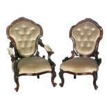 A late Victorian rosewood salon armchair with foliate top crest and acanthus detail to the frame,