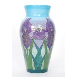A Dennis China Works vase decorated with tubelined purple iris against a tonal blue and purple