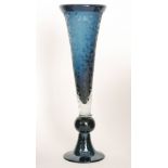 A large contemporary studio glass vase of trumpet form on ball knop and splayed foot,