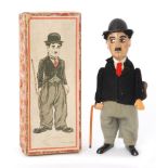 A 1920s Schuco Charlie Chaplin clockwork toy operates with spinning cane in original box with