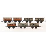 Four Bing O gauge milk traffic wagons and churns,