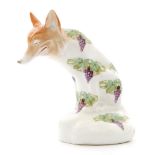 An early 20th Century Royal Doulton model of a seated fox with a wide grinning face,