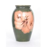 A Walter Moorcroft Coral Hibiscus pattern vase of tapering ovoid form decorated with pink tubelined