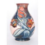 A boxed Moorcroft Pottery vase of baluster form decorated in the Red Tulip pattern designed by