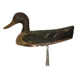 An early 20th Century naive carved plain wooden decoy duck with painted and lead weight to base and