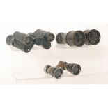A pair of early 20th Century adjustable binoculars with central compass mount,