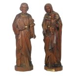 A pair of 1930s carved pine figures of the Virgin Mary holding the Christ child and a similar