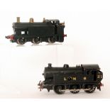 An O gauge 0-6-0 LMS tank locomotive in black livery No 21 and a 0-6-0 spirit fired tank loco also