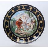 A late 19th to early 20th Century Vienna charger decorated with a transfer applied scene of cherubs