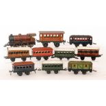An O gauge 0-6-0 locomotive 6508 in maroon livery class coaches, two green and white roofs ,