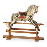 A dapple grey painted pine rocking horse in the manner of J.