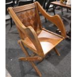 A late 19th Century oak Glastonbury chair, with parquetry inlaid back panel.