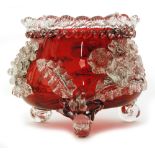 A large late 19th Century Stuart and Sons ruby glass bowl of circular form with a tri-form rim