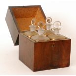 A George III mahogany apothecary box fitted with four gilt decorated square decanters and stoppers,