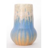A Ruskin Pottery 'Elephant's Foot' vase decorated in a crystalline pale yellow to streaked blue