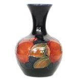 A small Moorcroft vase of mallet form decorated in the Pomegranate pattern with fruit and berries