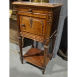 An early 20th Century French bedside cabinet with an inset rouge marble top,