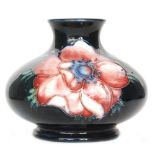 A small Moorcroft vase of compressed form decorated in the Anemone pattern with two tubelined