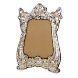 An Edwardian Art Nouveau hallmarked silver easel photograph frame with embossed central iris flower