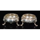 A pair of George II hallmarked silver circular open salts with engraved and embossed foliate