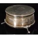 A hallmarked silver circular trinket box with engine turned decoration to hinged cover,