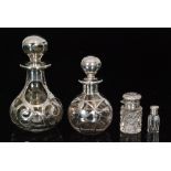 Four assorted scent bottles to include two overlaid silver examples a small silver and clear cut