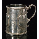 A Victorian hallmarked silver christening cup with three raised shield shaped panels,