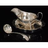 A hallmarked silver matching sauce boat, stand and ladle,