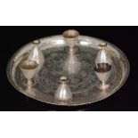 An Egyptian silver circular salver with Arabic script and foliate decoration within raised border,