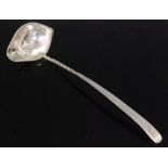 A George IV hallmarked silver cream ladle with elliptical shaped bowl below part twisted stem and