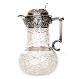 A hallmarked silver and clear cut glass claret jug,