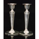 A pair of hallmarked silver candlesticks,