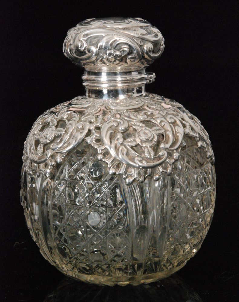 An early 20th Century hallmarked silver and glass globular scent bottle,