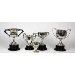 Five varied two handled silver Trophy Cups, various sizes, mostly Dublin c.