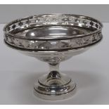 A late Victorian pierced silver Tazzi, the pierced and decorated rim on a tumbler and stepped base,