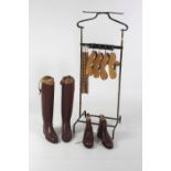 A modern Gentleman's Clothes Horse on brass supports and leather top,