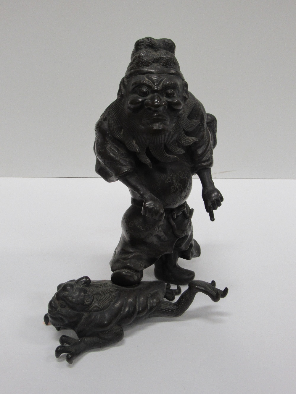 A good 19th Century Japanese bronze Figure of an Immortal in decorated costume,