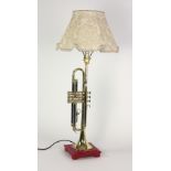 A rare and unusual Trumpet converted to a Lamp, with cream shade.