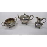 A fine quality Victorian three piece chased decorated Tea Set, comprising teapot,