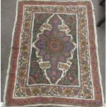 A colourful needlework Wall Hanging, with floral border surrounding central motif,