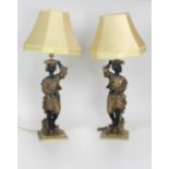 A pair of 19th Century Blackamoor figural Lamp Standards, on heavy moulded brass bases,